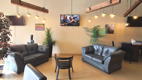 Wave 3D event and meeting space with leather seating, display screens and wood beam lighting